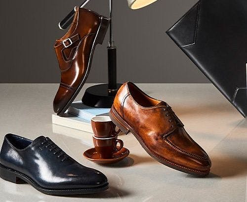 a bunch of dress shoe styles with stationery in the background