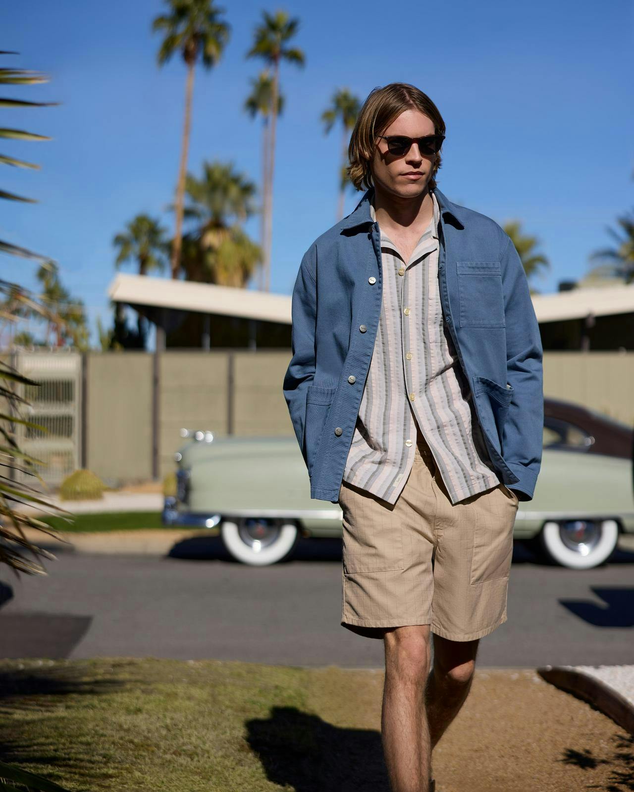 a man in sunglasses and a blue jacket in palm springs