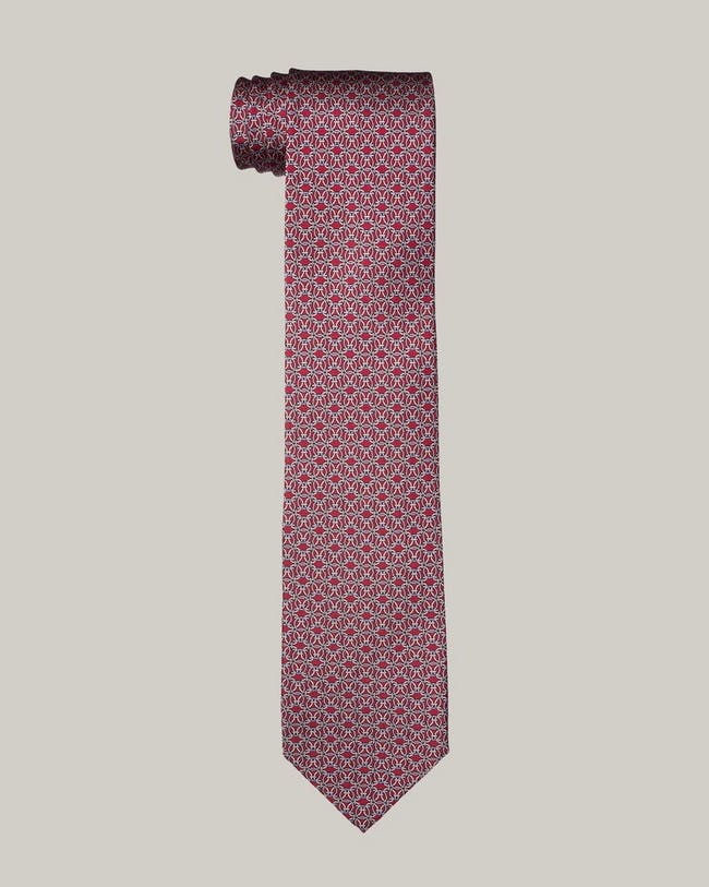 Une cravate rose avec un motif rouge dessus