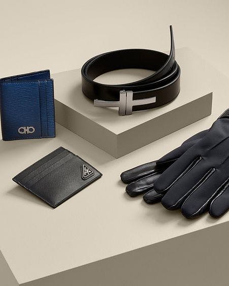 Gloves, small leather wallets, and a belt by various luxury brands.